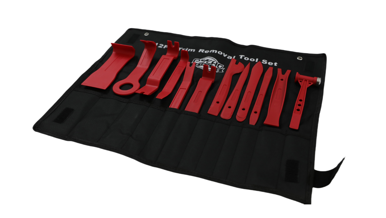 Set of red trim removal tools on a black roll-up mat with a white background